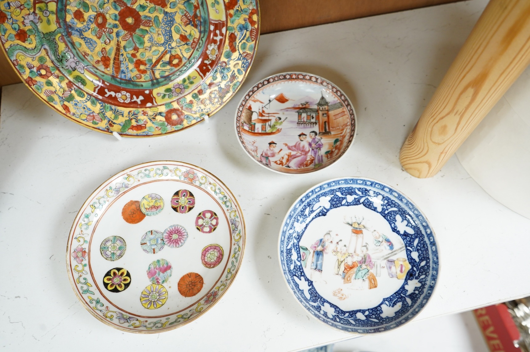 An 18th century Chinese clobbered dish, a famille rose dish, Guangxu six character mark and two 18th century Chinese export saucers, largest 22cm